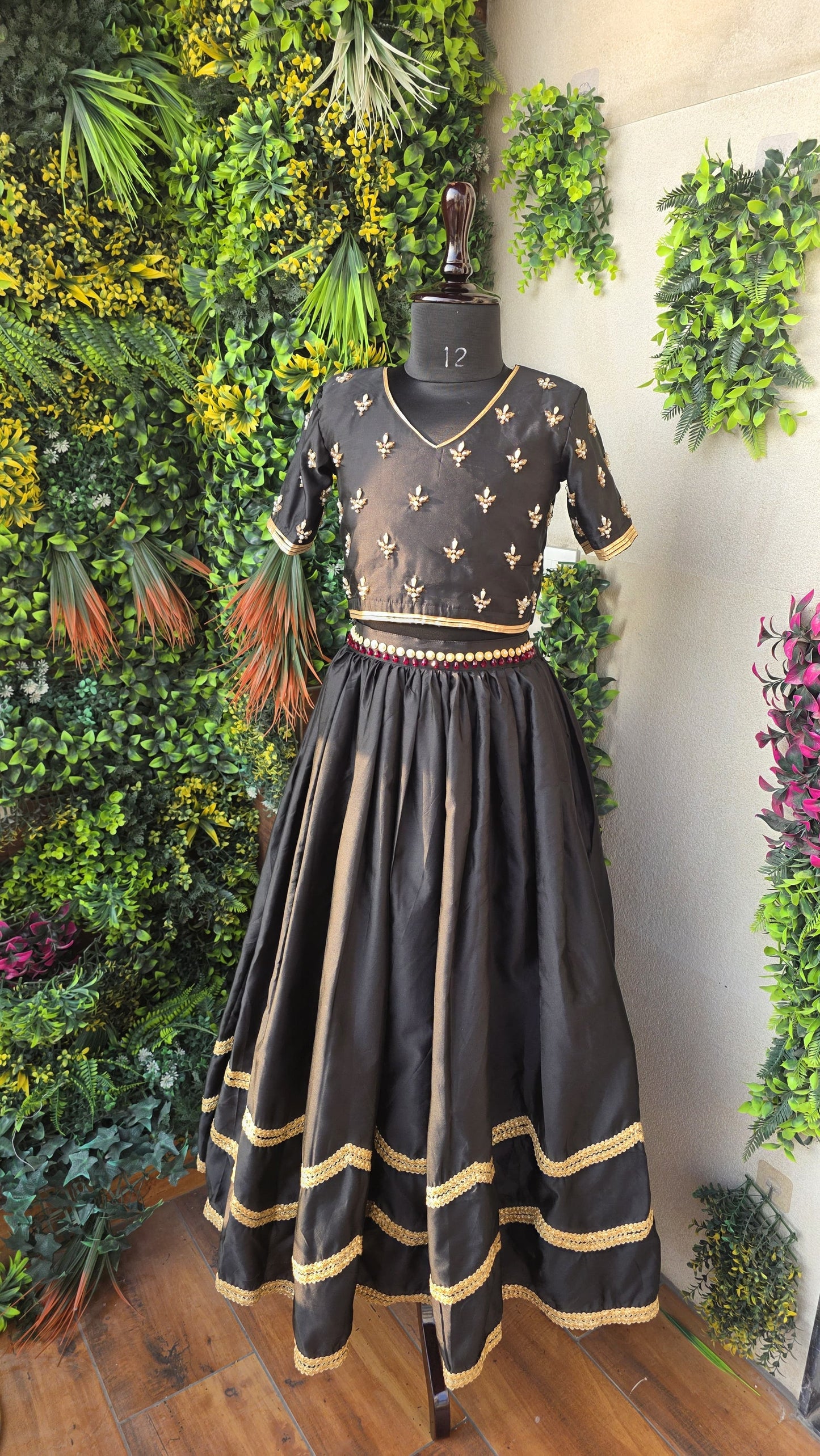 Pre Order: Sequins Floral Embroidered Short Sleeves Black Top And Contrasting Tassels Enhanced Lehenga With Matching Net Dupatta
